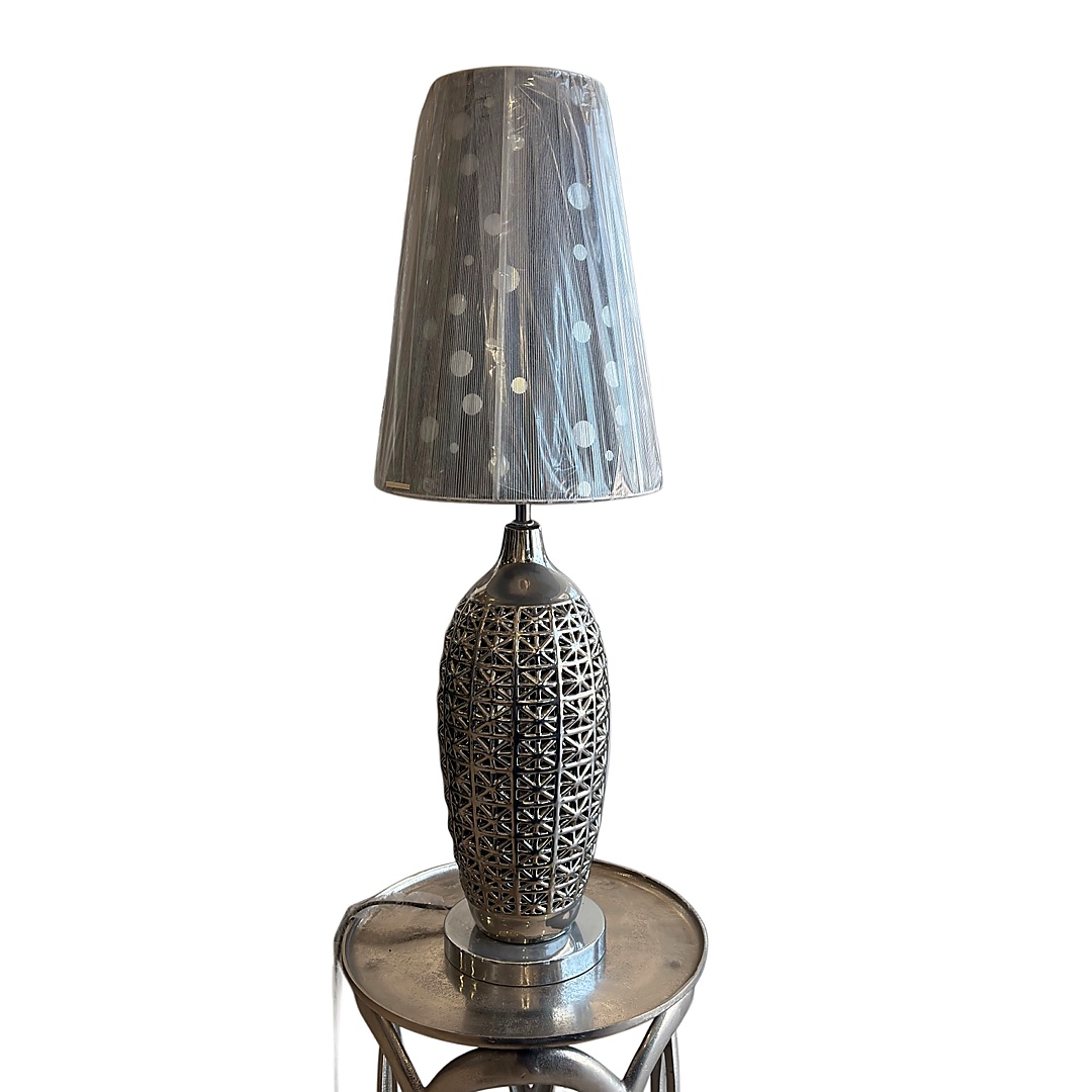 Contemporary table lamp designed with a metallic aesthetic and modern textures.
